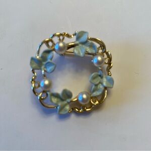 Elegant Gold Brooch with green leaves and white pearl like beads.